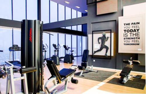 a gym with cardio equipment and a sign in the middle at 2 Bedroom 2 BATHROOM NEAR SUMWAY PYRAMID in Subang Jaya