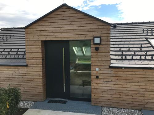 a brown house with a black door in it at Nussböckgut in Linz