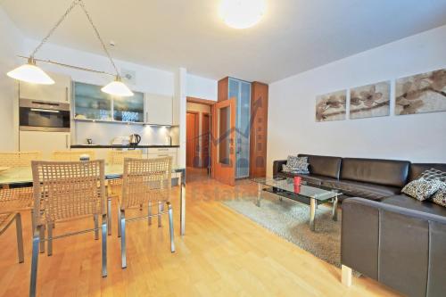 a living room with a couch and a table at St. Peter Apartment in Špindlerův Mlýn
