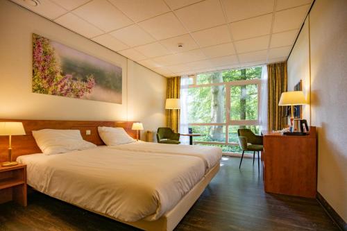 Giường trong phòng chung tại Fletcher Hotel Restaurant Amersfoort