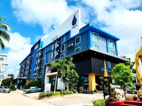 a blue building with a flag on top of it at Mantra Varee Hotel in Khon Kaen