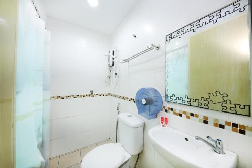 a bathroom with a toilet and a sink and a mirror at OYO 1055 Batu Caves Star Hotel in Batu Caves