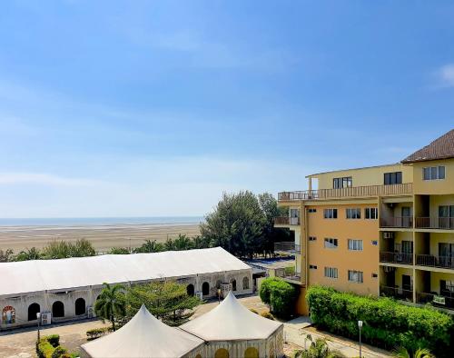a view of a building and tents in front of a building at Gold Coast Morib Studio l Apartment I Penthouse in Banting