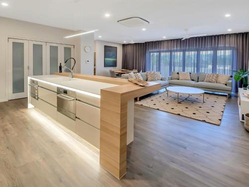 a kitchen with a large island in a living room at Superior Luxury Apartment in the City in Cairns