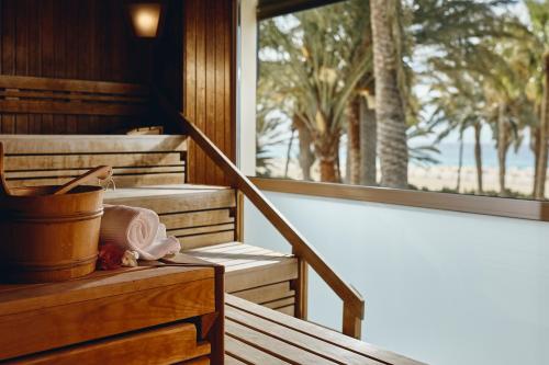 a wooden porch with a bucket and a window at ROBINSON JANDIA PLAYA - Adults only in Morro del Jable