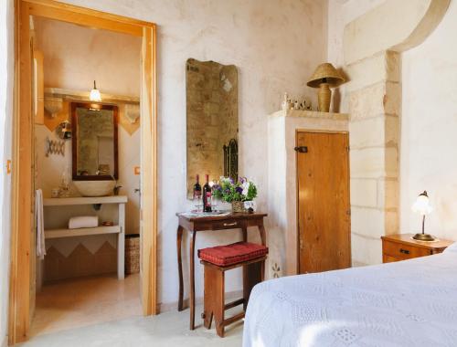 a bedroom with a bed and a table with a mirror at Borgoterra in Martano