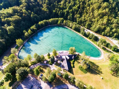 an aerial view of a large lake in the woods at Hotel Mladost in Tjentište