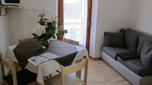 a living room with a table and a couch at ANESI appartamenti in Baselga di Pinè
