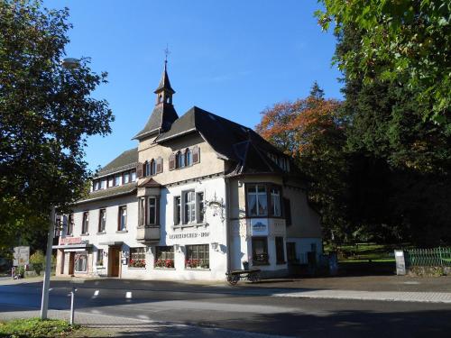 a large white building with a tower on top of it at Lenzkircher Hof in Lenzkirch