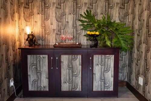 a wooden cabinet with flowers on top of it at Moya Safari Villa in Hoedspruit