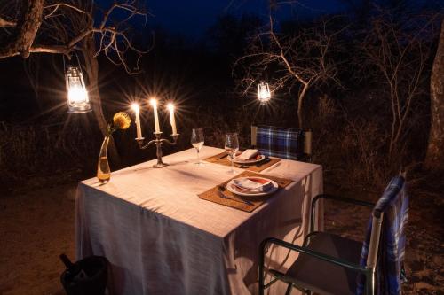 a table with candles on it at night at Moya Safari Villa in Hoedspruit