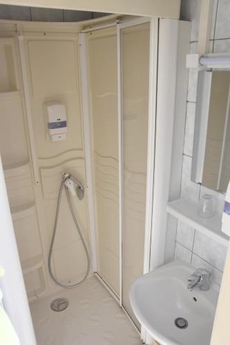 a bathroom with a shower and a sink at Hotel Gai Relais in Gérardmer