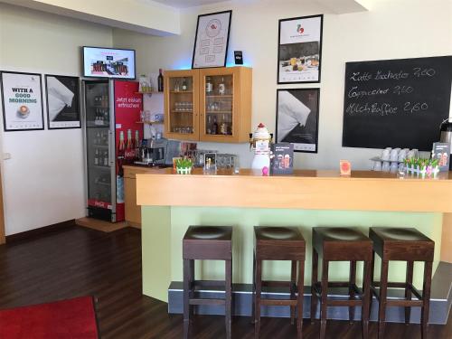 a kitchen with a table, chairs and a refrigerator at Good Morning Erfurt in Erfurt