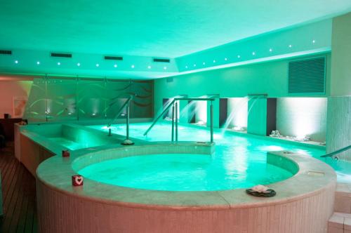 a large hot tub in a hotel room with at ARTEMIDE "Fiore Club" B&B SUITE SPA in Giffoni Valle Piana