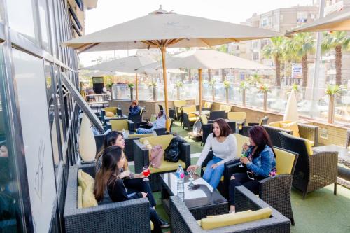 a group of people sitting in chairs in a restaurant at Hor Moheb Hotel in Cairo