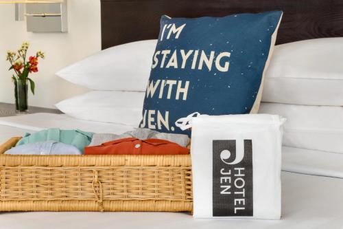 a basket of clothes on a table next to a bed at Jen Maldives Male by Shangri-La in Male City