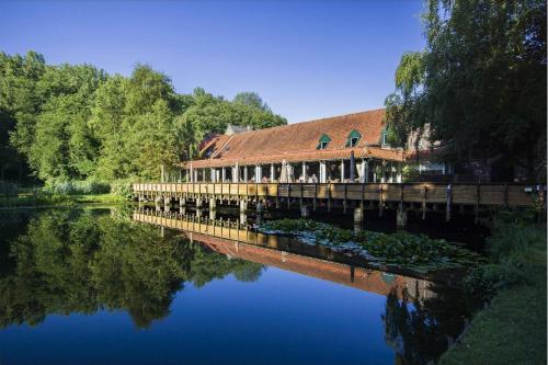 a building on a bridge over a river at Landgoed Overste Hof in Landgraaf