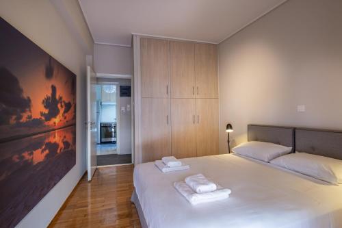 a bedroom with a bed with two towels on it at Demetra - Koukaki center apartment in Athens