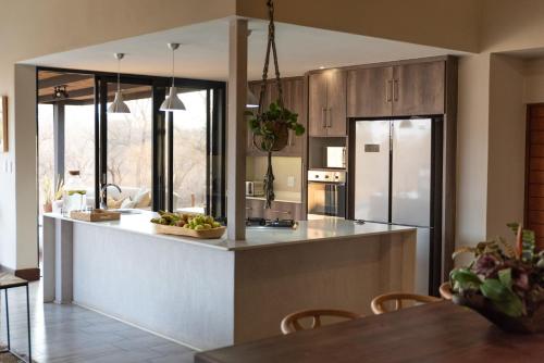 a kitchen with a large island in the middle at Moya Safari Villa in Hoedspruit