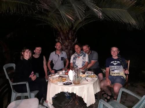 a group of people sitting around a table at BIS-A Guesthouse in Makhinjauri