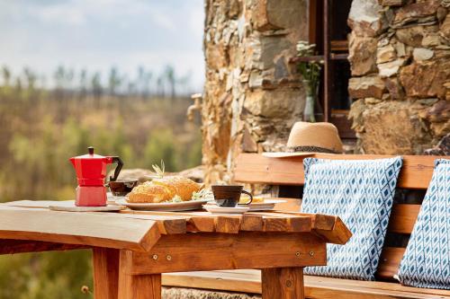 a wooden table with a plate of food on it at Moinho da Fadagosa in Mação