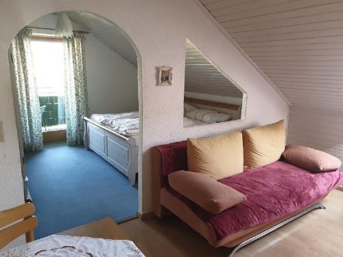a small bedroom with a bed and a mirror at Haus Sonne in Kirchham