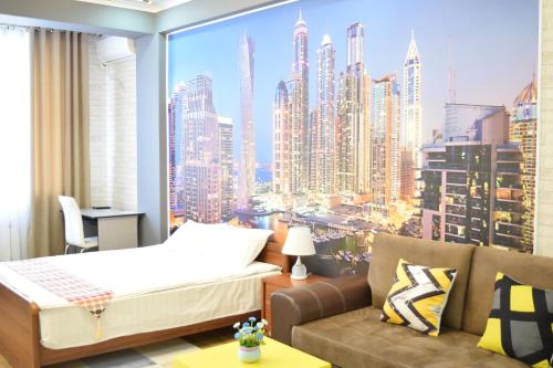 een slaapkamer met een bed en uitzicht op de stad bij Boutique apartment in the center in Bisjkek