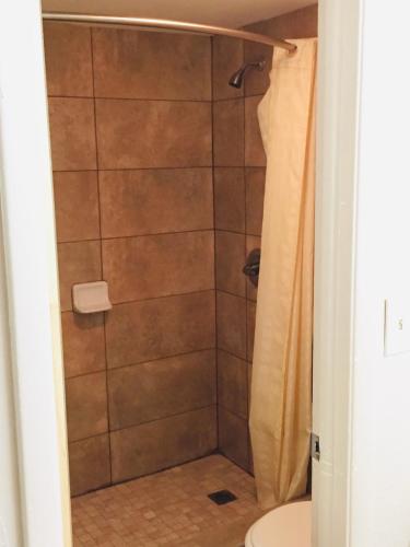 a bathroom with a shower with a toilet at Masters Inn in Seffner