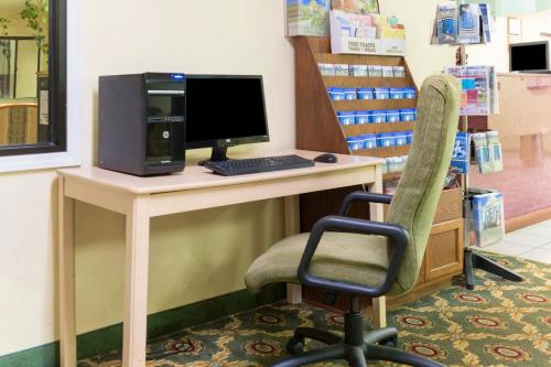 a desk with a computer and a chair in a store at Days Inn by Wyndham Mount Vernon in Mount Vernon