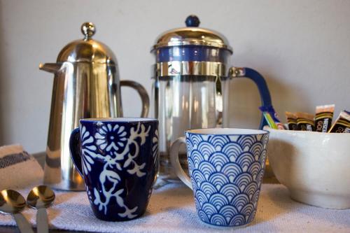 two blue and white cups sitting on a table at Moya Safari Villa in Hoedspruit