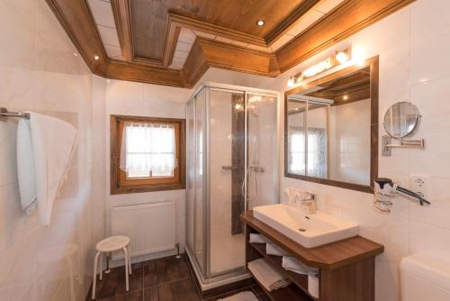 a bathroom with a sink and a shower at Stoffen Zuhaus in Alpbach
