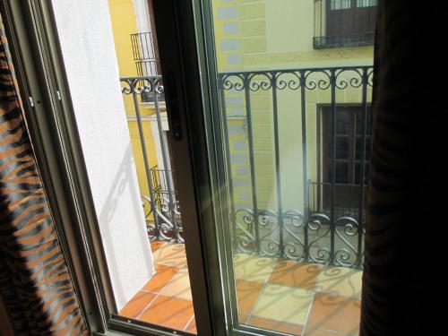 a view of a balcony from a window at Madrid City Rooms in Madrid