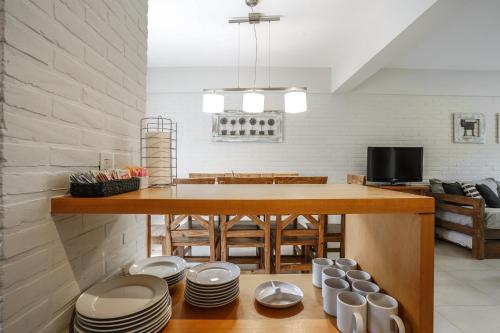 a kitchen with a table with plates on the floor at Valeria House Rental Suites in Valeria del Mar