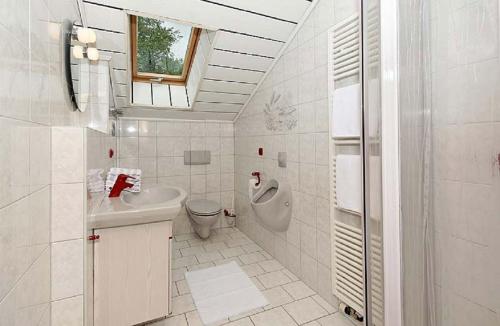 a white bathroom with a sink and a toilet at Ferienhof Scholz in Spiegelau