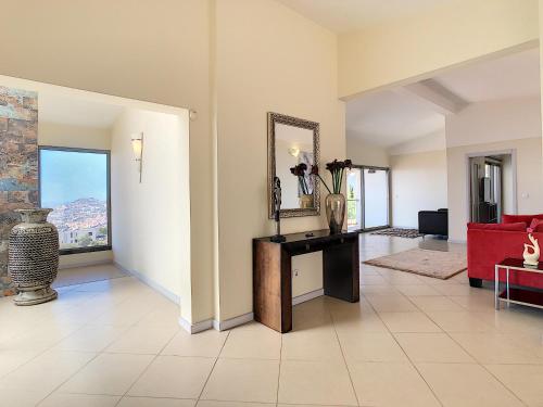a living room with a red couch and a mirror at Villa Moniz by LovelyStay in Funchal