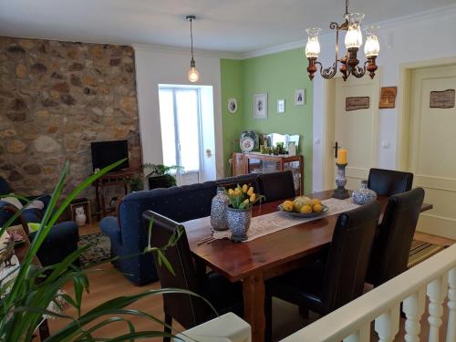 a dining room with a table and a blue couch at Casa Aurora in Penacova