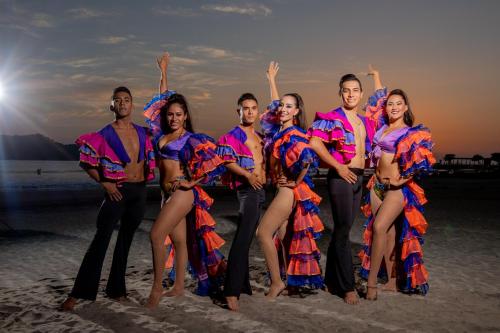 a group of people standing on the beach at Qualton Club Ixtapa All Inclusive in Ixtapa