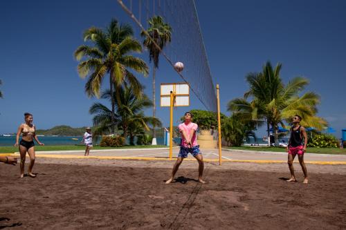 a group of people playing volleyball on the beach at Qualton Club Ixtapa All Inclusive in Ixtapa