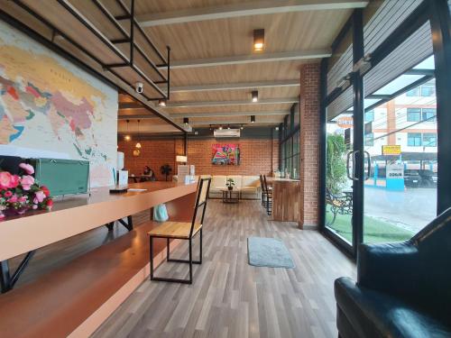 an office with a large window and a table and chairs at Sleep Airport Chiang Mai in Chiang Mai