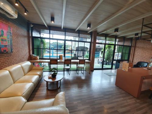 a living room with a couch and a table at Sleep Airport Chiang Mai in Chiang Mai