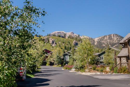 a street in a village with a mountain in the background at Snowcreek V 756 in Mammoth Lakes