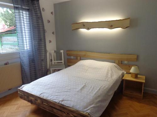 a bedroom with a bed and a window at GITE DES BOULEAUX in Maîche