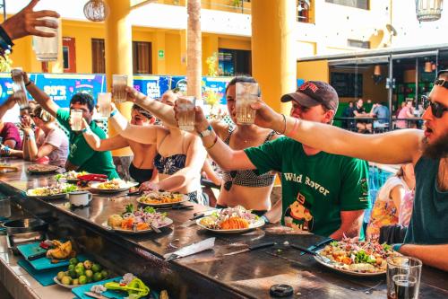 a large group of people preparing food in a restaurant at Wild Rover Huacachina in Ica