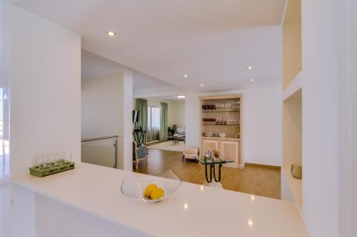 a kitchen with a white counter top and a living room at Vila Marina - Luxurious apartment - Sea view in Vilamoura
