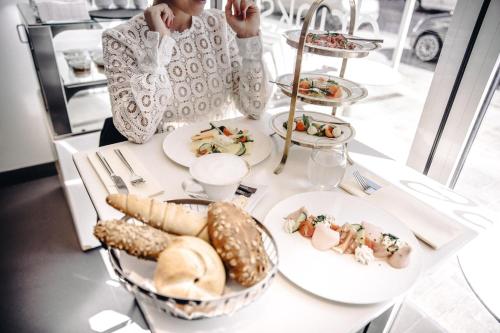 
a white table topped with plates of food at Iris Porsche Hotel & Restaurant in Mondsee
