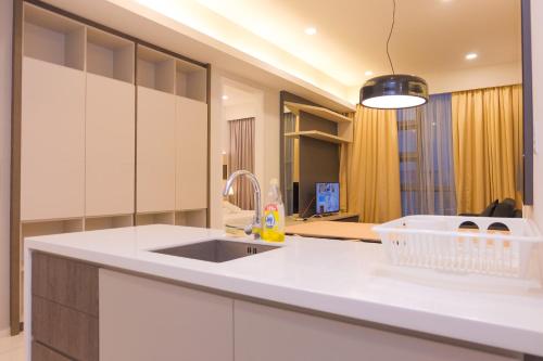a kitchen with white cabinets and a sink at The Robertson Bukit Bintang by Wowhome in Kuala Lumpur