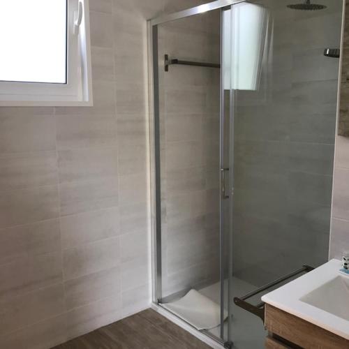 a shower with a glass door in a bathroom at Monte do Mosteiro CountryHouse in Batalha