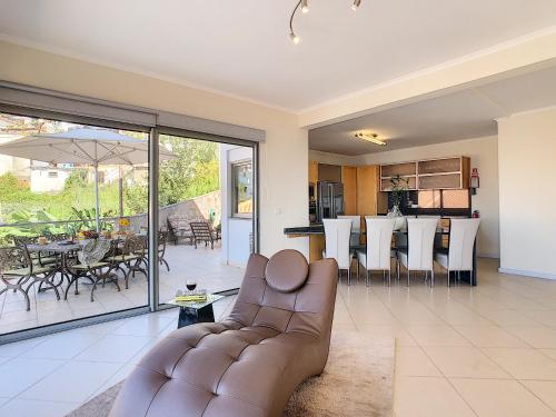 a living room with a couch and a dining room and kitchen at Villa Moniz by LovelyStay in Funchal