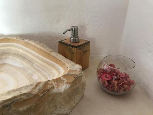 a sink and a bowl of flowers on a counter at Tierra del Mar Hotel - Adults Only in Holbox Island