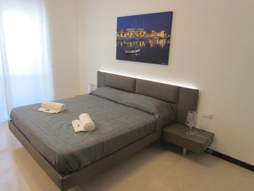 a bedroom with a bed with two towels on it at Room 56 - Le Dimore in Bari